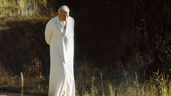 Pope John Paul II walks down a gravel path